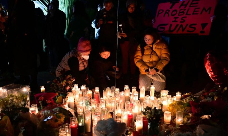 People pay tribute to the victims of the mass shooting at the Star Ballroom Dance Studio in Monterey Park.