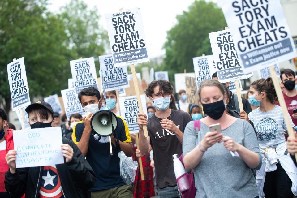 People take part in a protest marching from Downing Street to the Department of Education in Westminster, London, over the government's handling of A-level results. Thousands of pupils across England have expressed their disappointment at having their results downgraded after exams were cancelled due to coronavirus. Picture date: Friday August 14, 2020. Photo credit should read: Matt Crossick/Empics