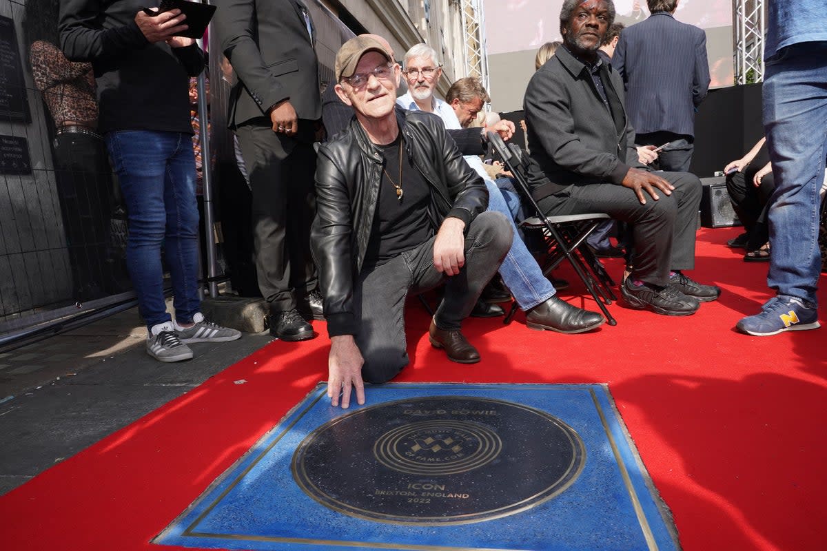 Woody Woodmansey next to a stone for David Bowie which was unveiled on the Music Walk of Fame at Camden, north London (Ian West/PA) (PA Wire)