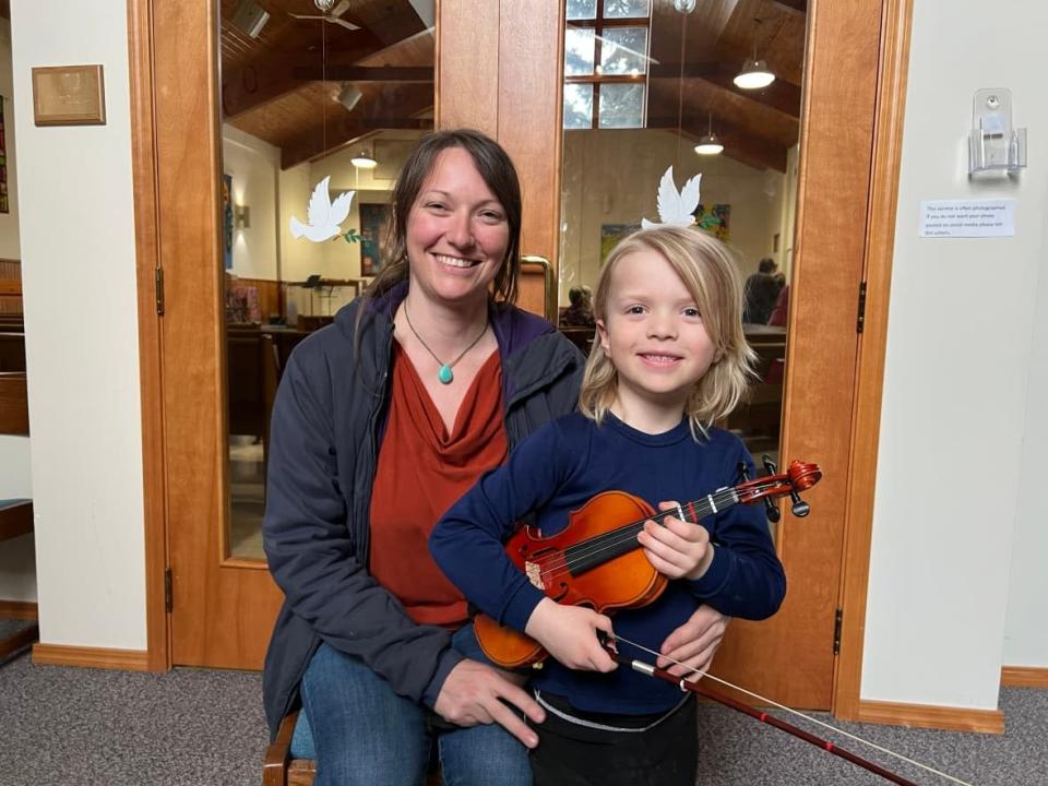 Chelsea Hamilton, left, and Brayden Marston, the mother-son duo, played the violin together for the first time at the Yukon Music Festival in Whitehorse United Church. (Sissi De Flaviis/CBC - image credit)