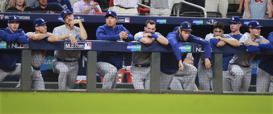 The Los Angeles Dodgers watch from the dugout in the ninth inning against the Atlanta Braves in Game 3 of MLB baseball's National League Division Series in Atlanta on Sunday, Oct. 7, 2018. Acuna had his first career grand slam in the game. The Braves won 6-5. (Curtis Compton/Atlanta Journal-Constitution via AP)