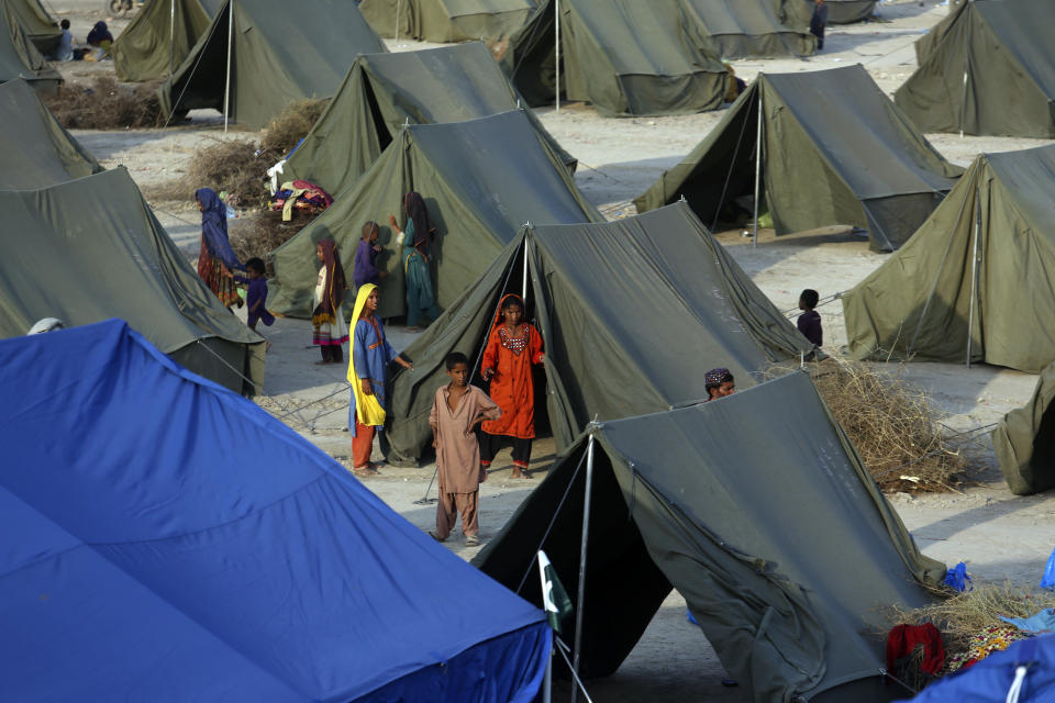 Temporary tent housing is constructed for flood victims organized by the Chinese government, in Sukkur, Pakistan, Wednesday, Sept. 7, 2022. (AP Photo/Fareed Khan)