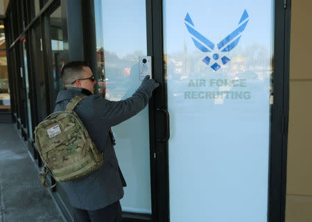 Nicholas Bade, 37, who is among the transgender Americans who this month can enlist openly in the U.S. military for the first time after courts blocked President Donald TrumpÕs effort to re-establish a ban on transgender service members, poses outside a recruitment center in Chicago, Illinois, U.S., January, 4, 2018. Photo taken January 4, 2018. REUTERS/Chris Kenning