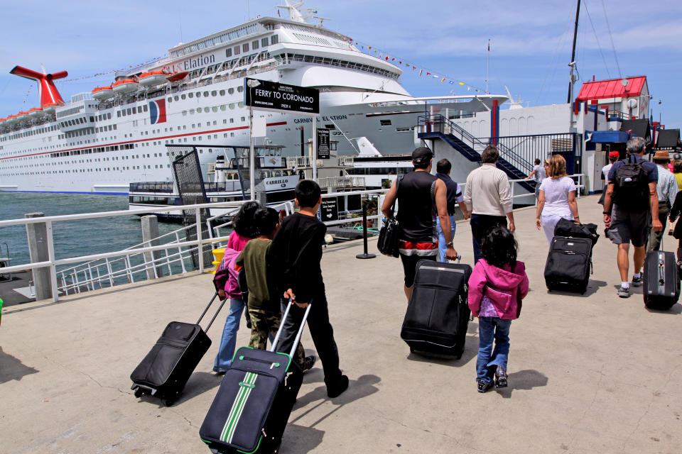 Cruise passengers board ship