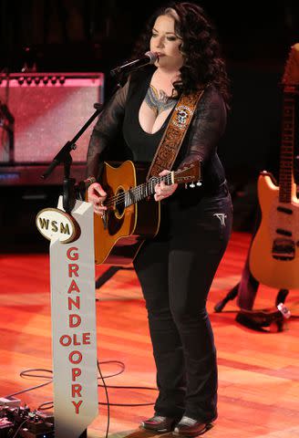 <p>Terry Wyatt/Getty </p> Ashley McBryde performs during the NASCAR Night At The Opry on December 03, 2019 in Nashville, Tennessee.