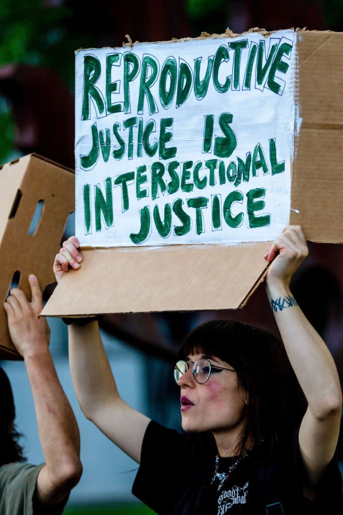 protester holds a placard saying 