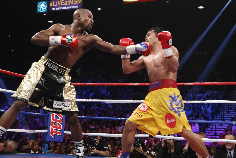 Floyd Mayweather (L) catches Manny Pacquiao with a jab in their heavily hyped 2015 fight. (Getty Images)