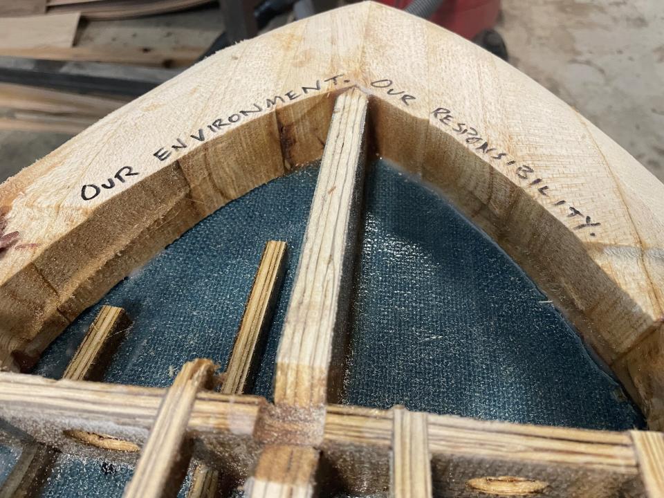 Ken Cole inscribed, "Our Environment. Our Responsibility," on the tail of his board made almost entirely out of sustainable and repurposed materials.