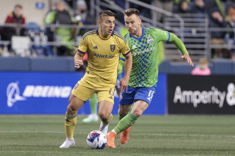 Real Salt Lake midfielder Braian Ojeda, left, moves the ball as Seattle Sounders midfielder Albert Rusnak defends during the second half of an MLS soccer match Saturday, March 4, 2023, in Seattle. The Sounders won 2-0. (AP Photo/Jason Redmond)