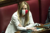 FILE - Leader of the Brothers of Italy party, Giorgia Meloni, wears a mask in the colors of the Italian flag as she attends a session at the Chamber of Deputies in Rome, Tuesday, April 21, 2020. The Brothers of Italy party has won the most votes in Italy’s national election. The party has its roots in the post-World War II neo-fascist Italian Social Movement. Giorgia Meloni has taken Brothers of Italy from a fringe far-right group to Italy’s biggest party. (Roberto Monaldo/LaPresse via AP, File)
