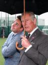 <p>TV presenter Anthony McPartlin enjoys the shelter provided by Prince Charles's umbrella.<br></p>