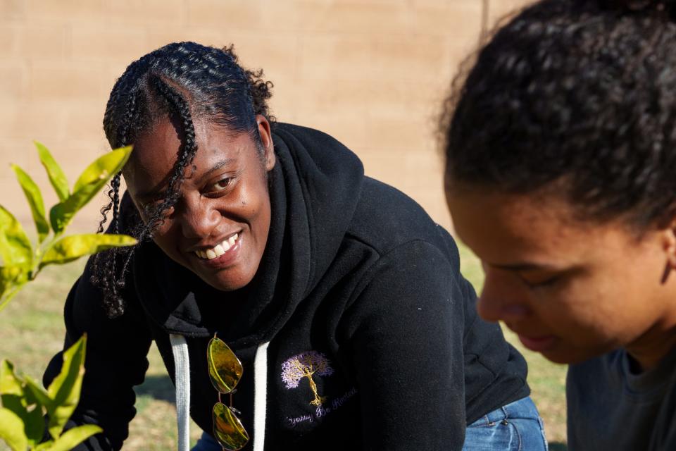 Keosha Anderson (left) and Olivia Smith work in the gardens at Tiger Mountain Foundation community school in Phoenix on Nov. 3, 2023.