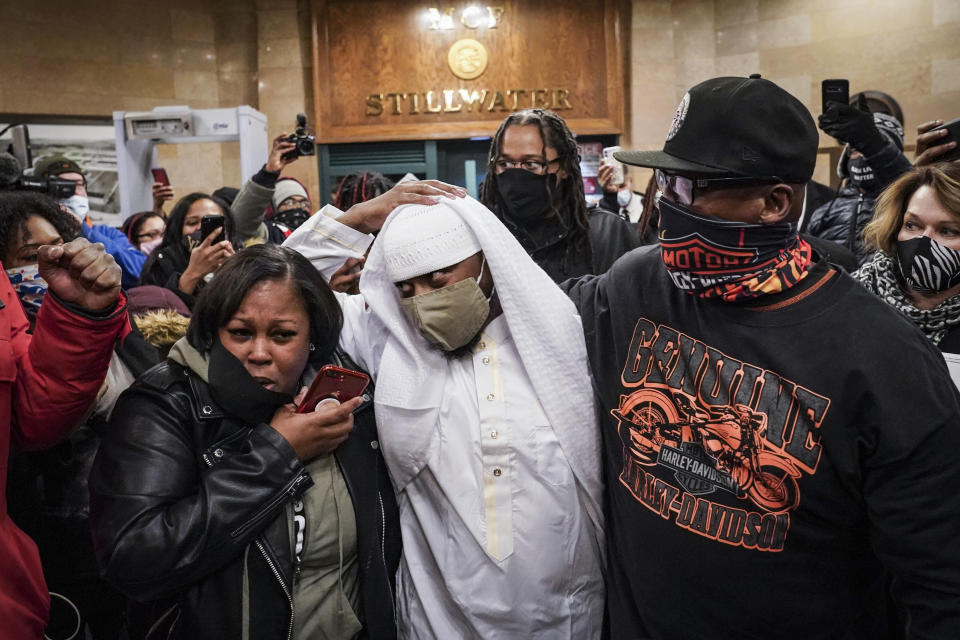 FILE - Myon Burrell, center, is released from Minnesota Correctional Facility-Stillwater, Tuesday, Dec. 15, 2020, in Bayport, Minn. Burrell, a Black man who was sent to prison for life as a teenager but was set free in 2020 after 18 years behind bars, was arrested in a Minneapolis suburb Tuesday, Aug. 29, 2023, on potential gun and drug charges. (AP Photo/John Minchillo, File)