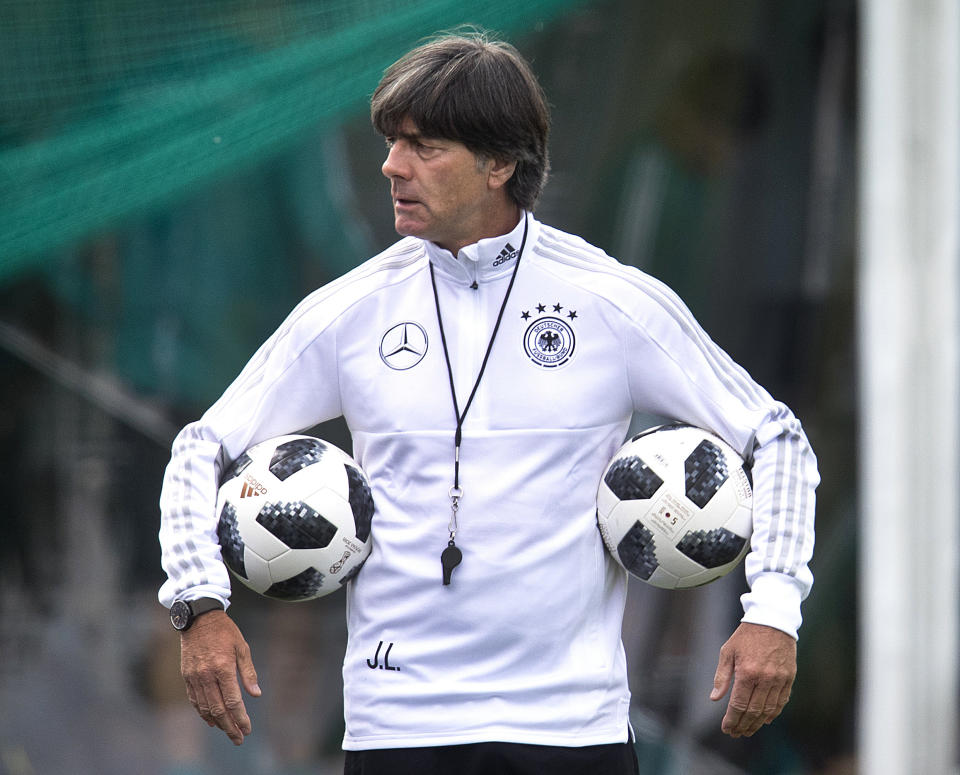 FILE - In this June 14, 2018 file photo, Coach of German national soccer team Joachim Loew carries two balls during a training session at the 2018 soccer World Cup in Vatutinki near Moscow, Russia. (AP Photo/Michael Probst,File)