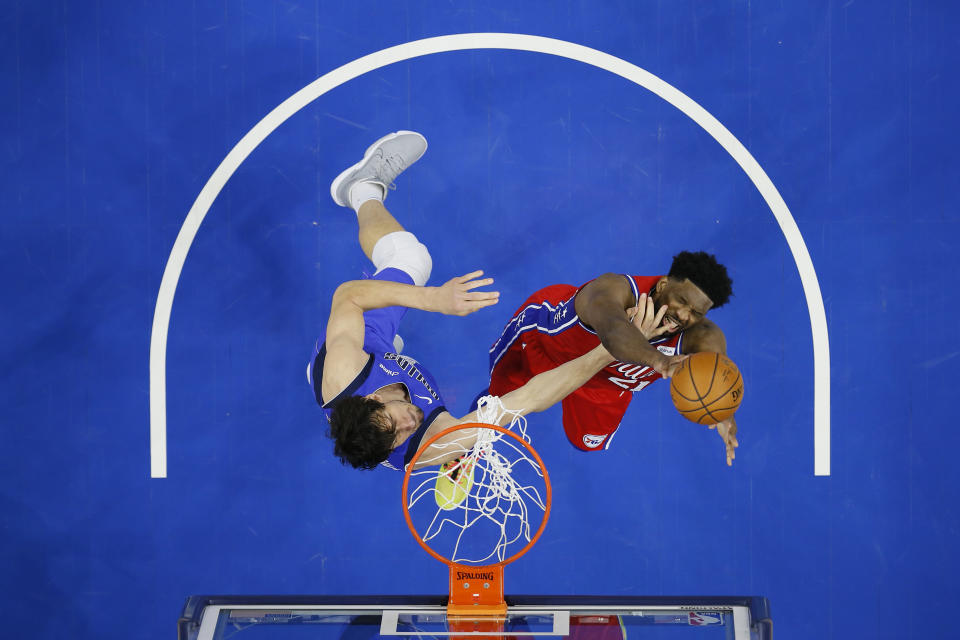 Philadelphia 76ers' Joel Embiid, right, tries to get a shot past Dallas Mavericks' Boban Marjanovic during the first half of an NBA basketball game, Thursday, Feb. 25, 2021, in Philadelphia. (AP Photo/Matt Slocum)