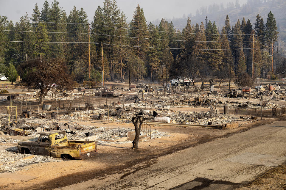 Homes destroyed by the Mill Fire line Wakefield Ave. on Saturday, Sept. 3, 2022, in Weed, Calif. (AP Photo/Noah Berger)