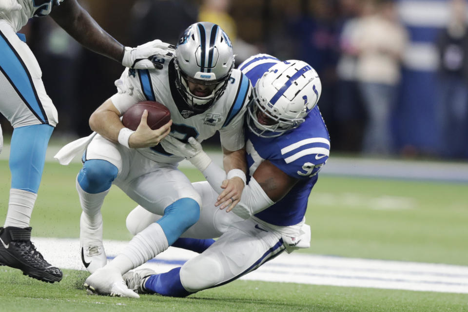 Carolina Panthers quarterback Will Grier (3) is sacked by Indianapolis Colts' Al-Quadin Muhammad (97) during the second half of an NFL football game, Sunday, Dec. 22, 2019, in Indianapolis. (AP Photo/Michael Conroy)