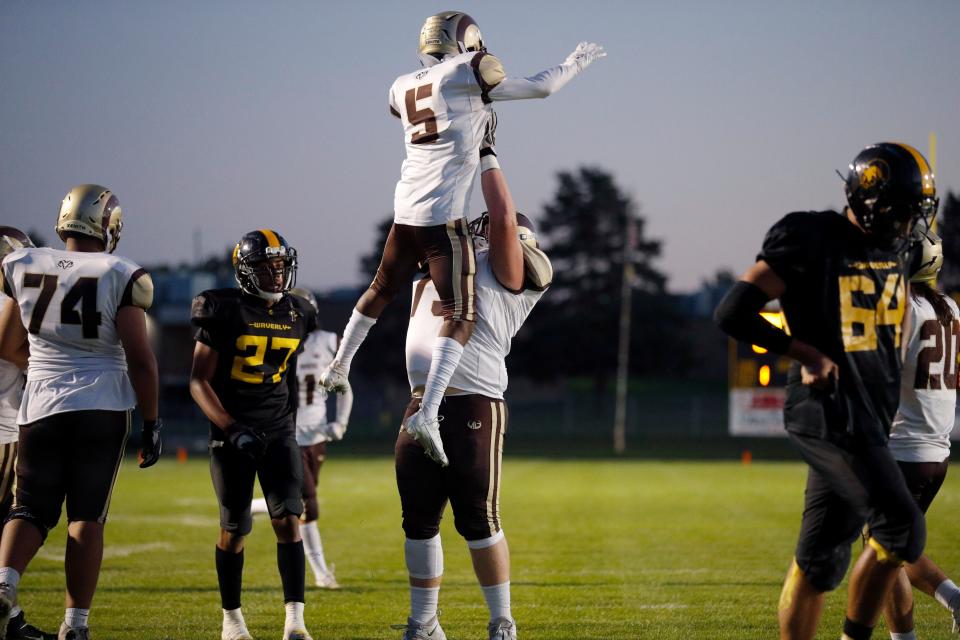 Holt's Charles Thompson (5) is lifted by Kory Jones as they celebrate Thompson's touchdown against Waverly, Friday, Sept. 30, 2022, at Waverly High School. Holt won 30-6.