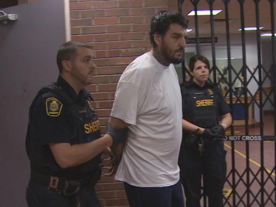 Matthew Fowler is led into court on Friday. (Curtis Hicks/CBC - image credit)