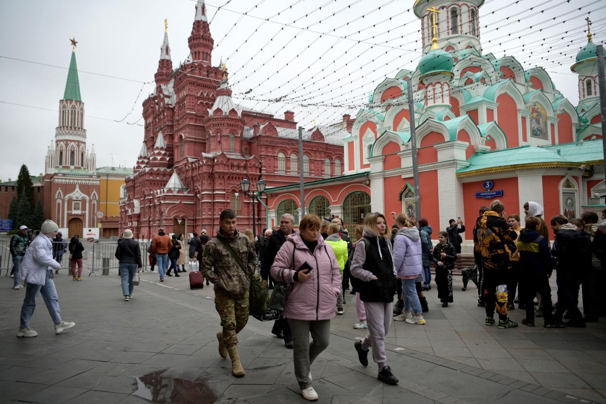 People walk down Nikolskaya Street outside Red Square in central Moscow on September 28, 2022.