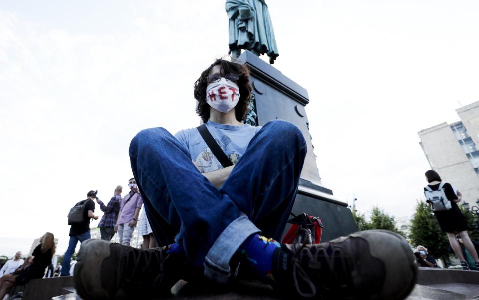 A protester with "No" written over his face mask sits down during a rally against constitutional amendments in Moscow - Sefa Karacan/Anadolu Agency via Getty Images