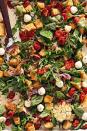 <p>Rather than toast the bread cubes on their own for this <a href="https://www.delish.com/cooking/recipe-ideas/g2877/summer-salads/" rel="nofollow noopener" target="_blank" data-ylk="slk:summery salad;elm:context_link;itc:0;sec:content-canvas" class="link ">summery salad</a>, you'll roast them alongside tomatoes, onion, and garlic. The tomatoes burst as they roast, mixing their juices with the bread and fresh arugula. The combination of roasted tomatoes, toasted bread coated with Parmesan, fragrant garlic, and mozzarella ends up tasting like <a href="https://www.delish.com/cooking/recipe-ideas/a24893663/homemade-pizza-recipe/" rel="nofollow noopener" target="_blank" data-ylk="slk:pizza;elm:context_link;itc:0;sec:content-canvas" class="link ">pizza</a>. Yum!</p><p>Get the <strong><a href="https://www.delish.com/cooking/recipe-ideas/a39725163/sheet-pan-panzanella-recipe/" rel="nofollow noopener" target="_blank" data-ylk="slk:Sheet-Pan Panzanella recipe;elm:context_link;itc:0;sec:content-canvas" class="link ">Sheet-Pan Panzanella recipe</a></strong>.</p>
