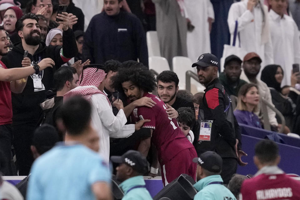 Qatar's Akram Afif, centre, celebrates after scoring his side's third goal during the Asian Cup Group A soccer match between Qatar and Lebanon at the Lusail Stadium in Lusail, Qatar, Friday, Jan. 12, 2024. (AP Photo/Thanassis Stavrakis)