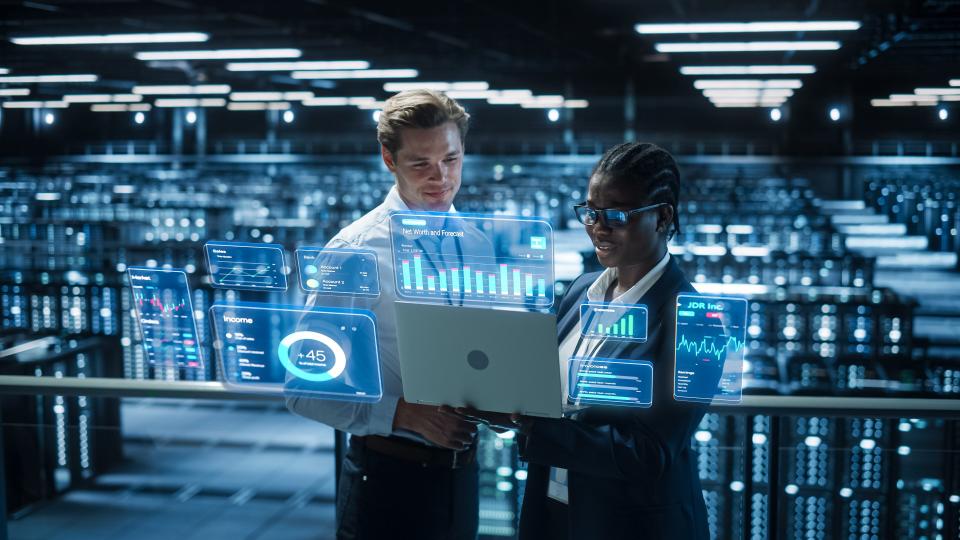 Technical Engineer and Project Administrator Using Computer in Modern Data Center Server Room Facility.