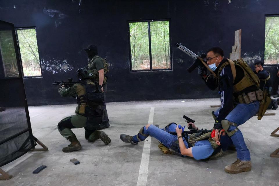 Trainees work on a simulated hostage rescue mission during an airsoft gun training lesson (Reuters)