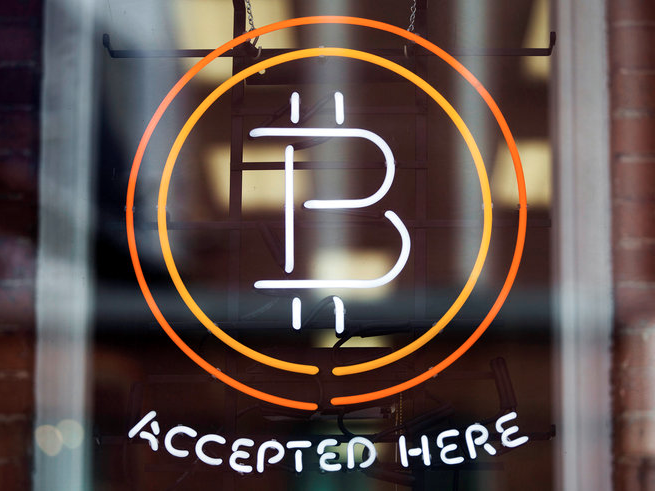 FILE PHOTO - A Bitcoin sign is seen in a window in Toronto, May 8, 2014.   REUTERS/Mark Blinch/File Photo