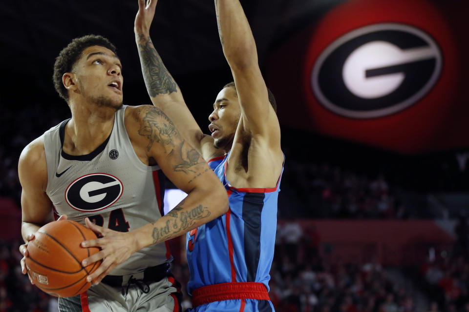 Georgia's Rodney Howard (24) looks to shoot while defended by Mississippi forward KJ Buffen (5) during an NCAA college basketball game in Athens, Ga., Saturday, Jan. 25, 2020. (Joshua L. Jones/Athens Banner-Herald via AP)