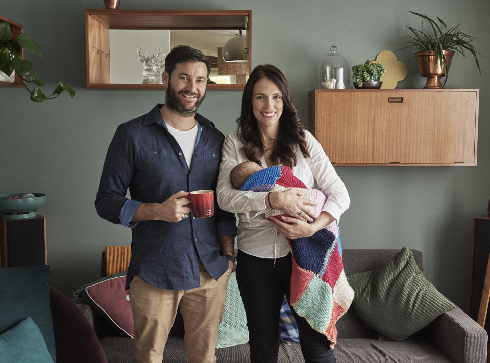 In this Aug. 1, 2018, photo supplied by Jacinda Ardern, New Zealand Prime Minister Jacinda Ardern, right, poses for a family portrait with partner Clarke Gayford and their baby daughter Neve in their home in Auckland, New Zealand. Ardern, just the second elected world leader to give birth while holding office, returned to work Thursday, Aug. 2, 2018, after six weeks maternity leave. (Derek Henderson/Jacinda Ardern via AP)