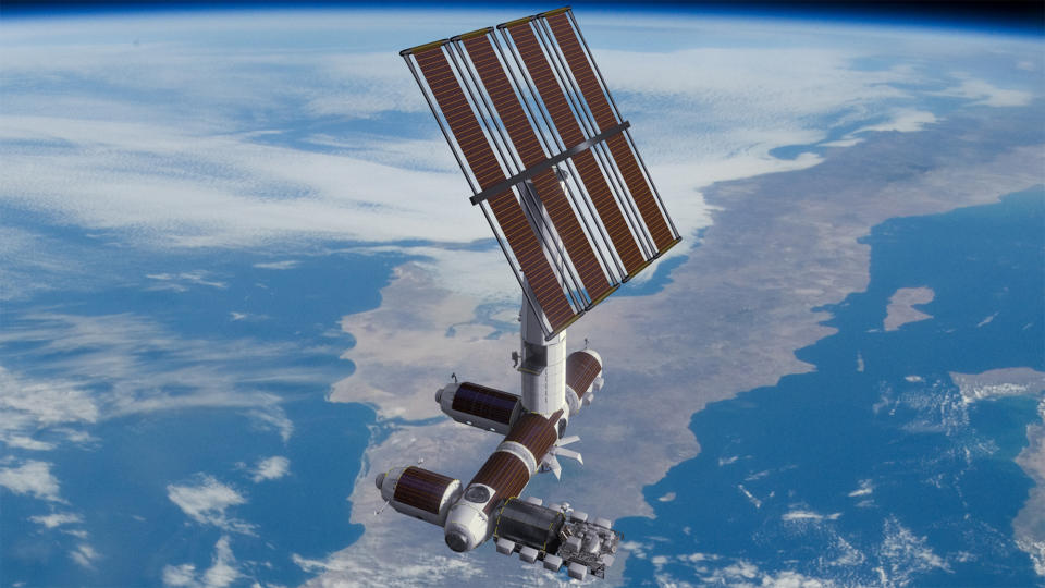 an E-shaped space station with a large solar panel array floats above a blue-and-white Earth