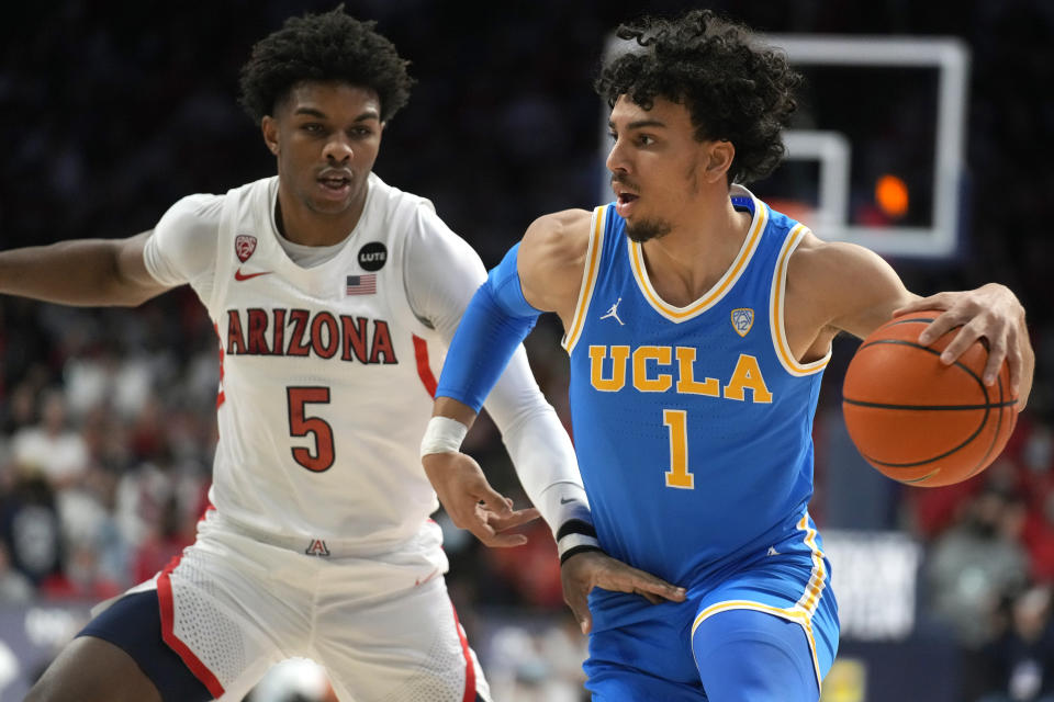 UCLA guard Jules Bernard drives past Arizona guard Justin Kier (5) during the first half of an NCAA college basketball game Thursday, Feb. 3, 2022, in Tucson, Ariz. (AP Photo/Rick Scuteri)