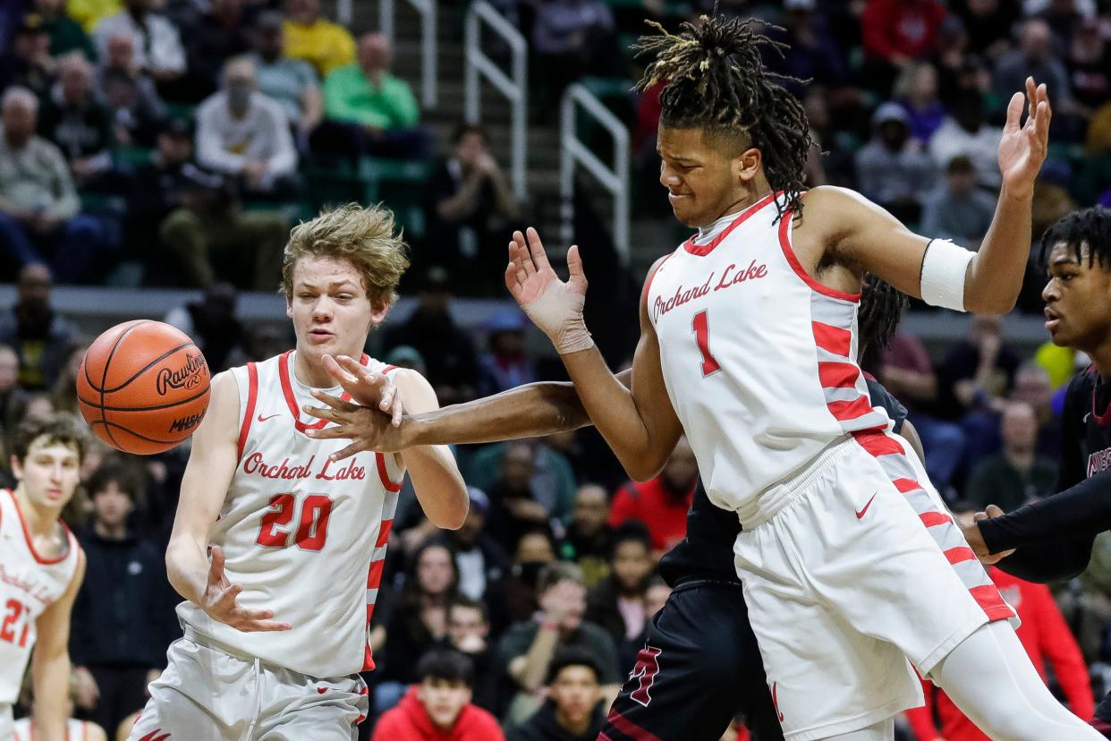 Orchard Lake St. Mary's center Mason Wisniewski (20) and  guard Trey McKenney (1) box out Muskegon guard James Martin (12) during the first half of MHSAA boys Division 1 semifinal at Breslin Center in East Lansing on Friday, March 24, 2023.