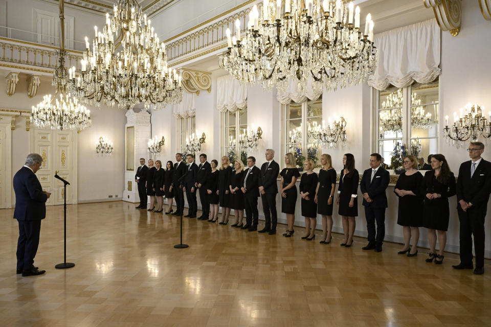 Finland's President of Finland Sauli Niinisto, left, delivers his message to the new Prime Minister Petteri Orpo, far left, and his cabinet, on the occasion of a complimentary visit to the President of Finland Sauli Niinisto at the Presidential Palace in Helsinki, Finland, Tuesday June 20, 2023. (Jussi Nukari/Lehtikuva via AP)