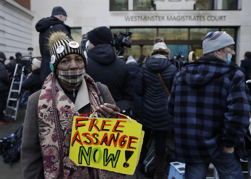 A Julian Assange supporter holds up a placard outside Westminster Magistrates Court as his bail hearing is held at the court in London, Wednesday, Jan. 6, 2021. On Monday Judge Vanessa Baraitser ruled that Julian Assange cannot be extradited to the US. because of concerns about his mental health. Assange had been charged under the US's 1917 Espionage Act for "unlawfully obtaining and disclosing classified documents related to the national defence". Assange remains in custody, the US. has 14 days to appeal against the ruling.(AP Photo/Matt Dunham)