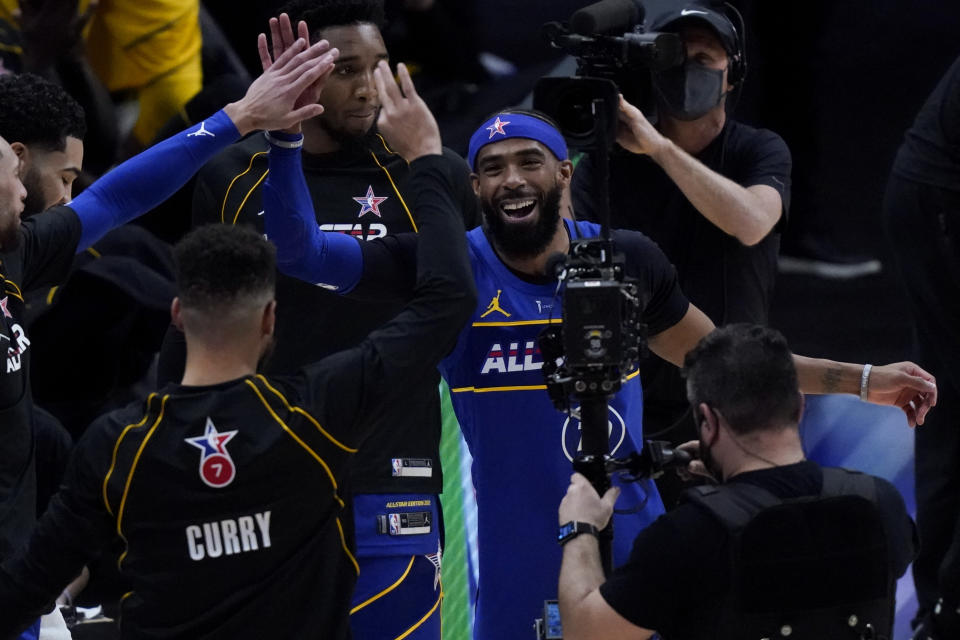 Golden State Warriors guard Stephen Curry and Utah Jazz guard Mike Conley celebrate during the first half of basketball's NBA All-Star Game in Atlanta, Sunday, March 7, 2021. (AP Photo/Brynn Anderson)