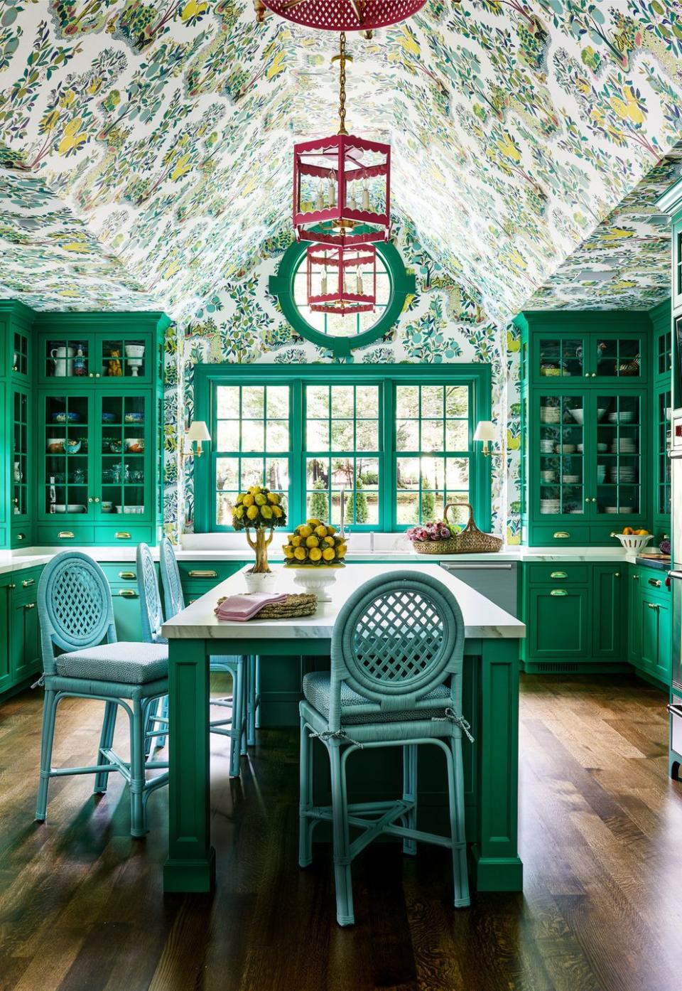 the custom green cabinetry in this kitchen by designer molly singer complements the wallpaper by schumacher