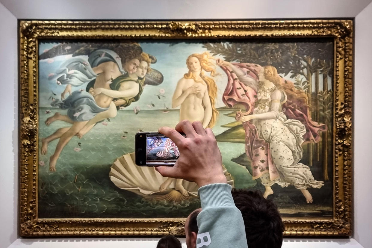 Visitors view and photograph the iconic painting The Birth of Venus (Nascita di Venere)