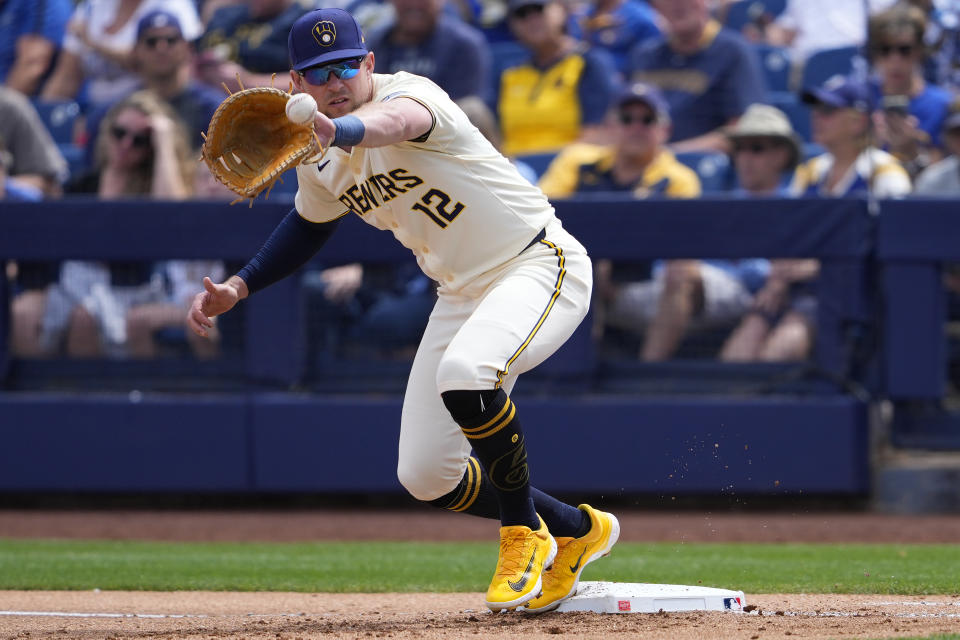 Milwaukee Brewers first baseman Rhys Hoskins fields a throw during the first inning of a spring training baseball game against the Los Angeles Angels, Monday, March 18, 2024, in Phoenix. (AP Photo/Matt York)