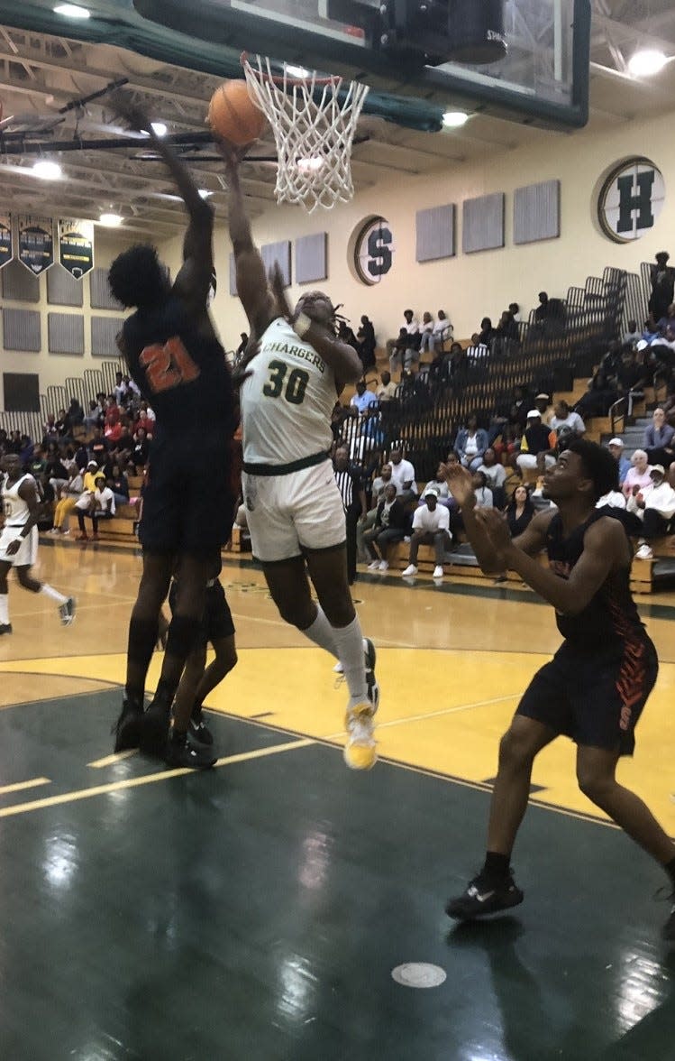 Suncoast center Ian Smikle (30) goes up for a shot against Stranahan forward Joshua Vedrine during the second half Friday night in Riviera Beach.