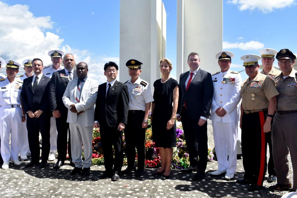 This picture taken on August 7, 2022, shows Japan's Defence Minister Makoto Oniki (5th L), Japan's Chief of Staff, Joint Staff General Koji Yamazaki (C), posing for pictures with US Ambassador to Australia Caroline Kennedy (5th R) and Australian Minister for International Development and the Pacific and the Minister for Defence Industry Pat Conroy (4rth R) during a ceremony marking the 80th anniversary of the Battle of Guadalcanal at Skyline Ridge in Honiara on the Solomon Islands. - A man described as 