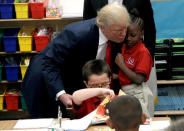 Republican presidential nominee Donald Trump hugs a student after receiving a bible as a gift during a campaign visit to the International Church of Las Vegas and the International Christian Academy in Las Vegas, Nevada, U.S., October 5, 2016. REUTERS/Mike Segar