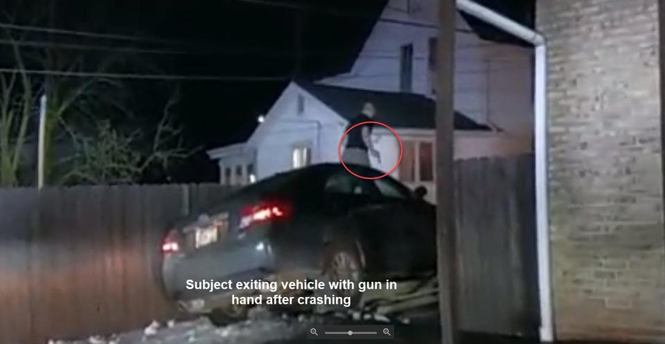 Police provided this captioned image from body-worn camera footage which shows Brandon Zurkan exiting his crashed car with a gun in his hand.