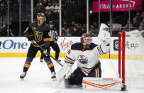 Edmonton Oilers goaltender Mikko Koskinen (19) makes a glove-save as Vegas Golden Knights right wing Evgenii Dadonov (63) looks on during the second period of an NHL hockey game Friday, Oct. 22, 2021, in Las Vegas. (AP Photo/Steve Marcus)