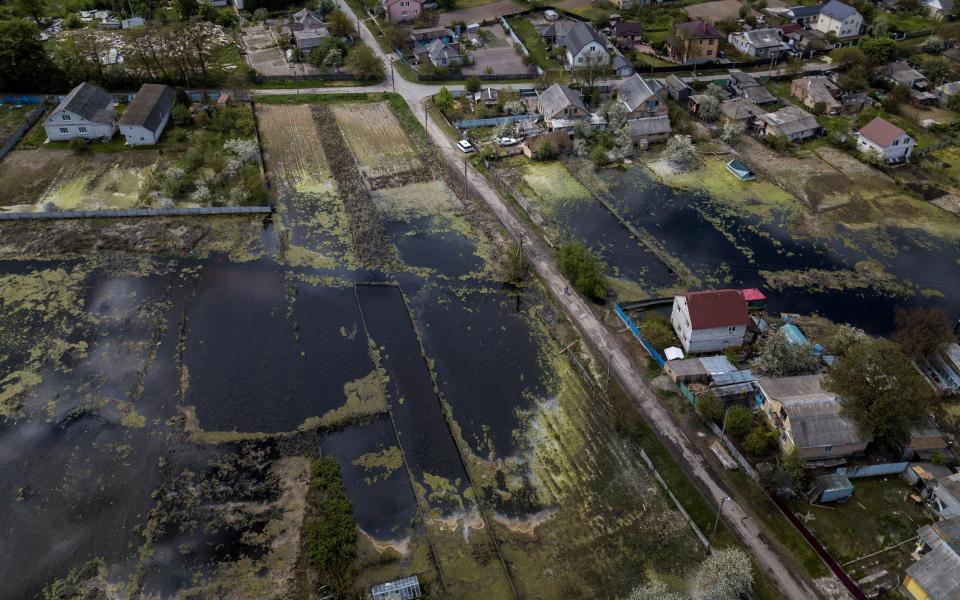 Houses are seen at a flooded area after Ukrainian military forces opened a dam to flood an residencial area in order to stop advance of Russian forces - CARLOS BARRIA 