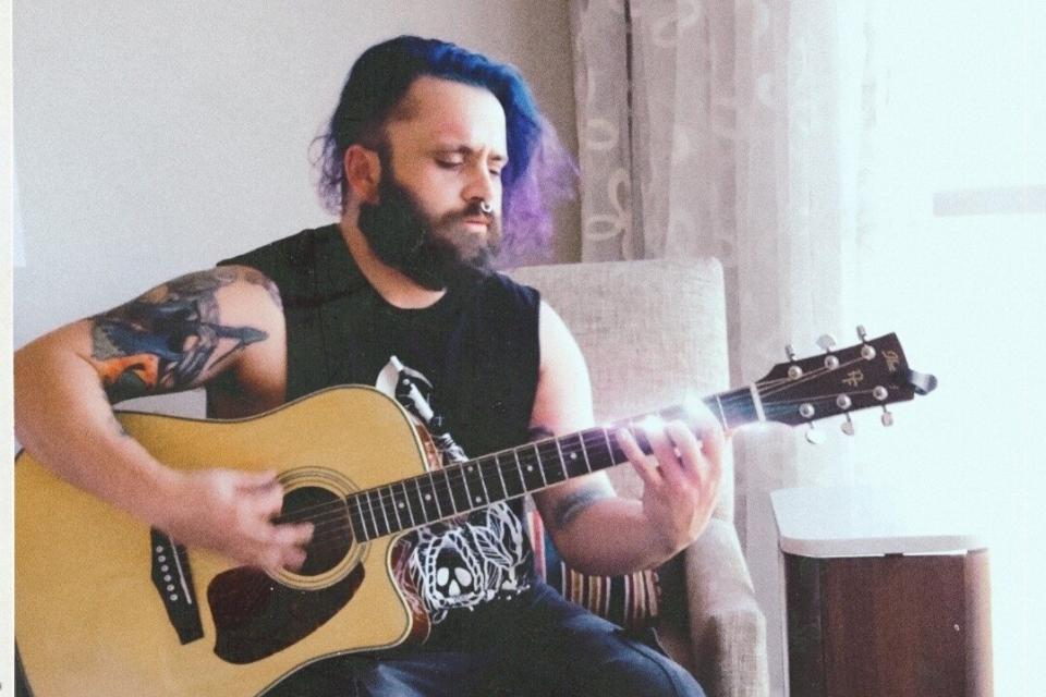 Justin Coffman, the bassist in a punk rock band, is facing felony charges after posting images from an album photo shoot. (Photo: Courtesy of Leah Harris)