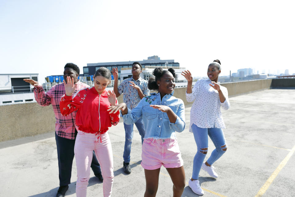 Young people dancing in a parking garage