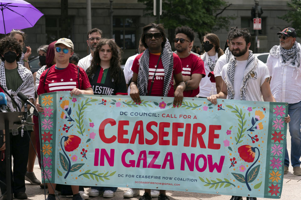 People holding a banner attend a news conference after police cleared a pro-Palestinian tent encampment at George Washington University early Wednesday and arrested demonstrators, Wednesday, May 8, 2024, in Washington. (AP Photo/Jose Luis Magana)
